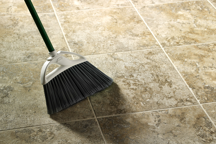sweeping up vinyl flooring with a travertine look