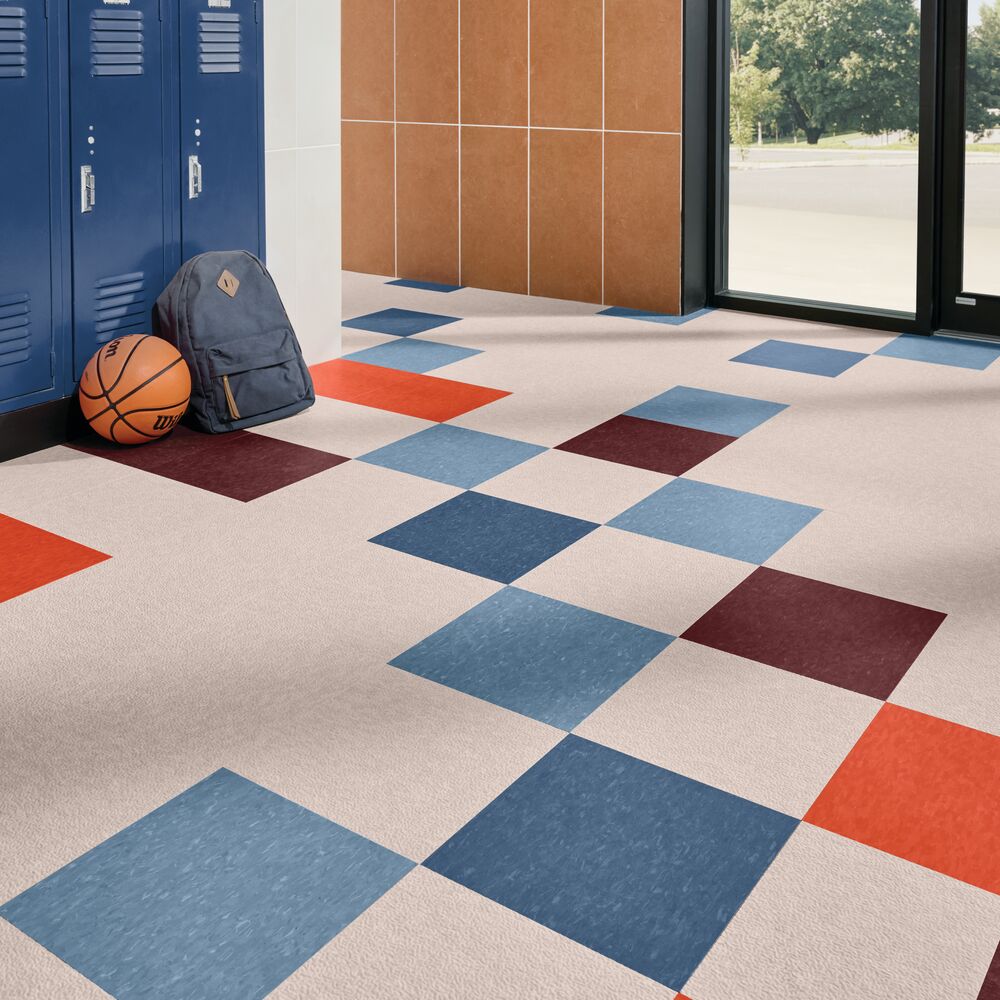 Color-matched slip-retardant tile in a school corridor with lockers
